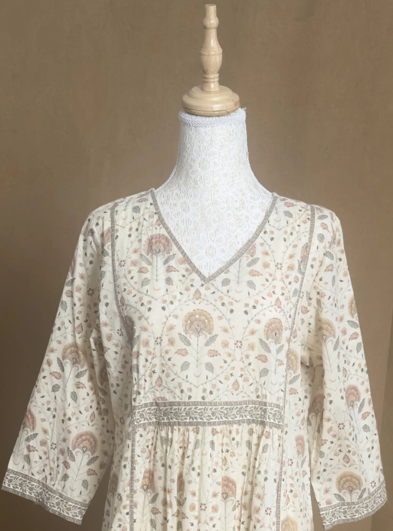 Floral patterned blouse on a mannequin against a brown background