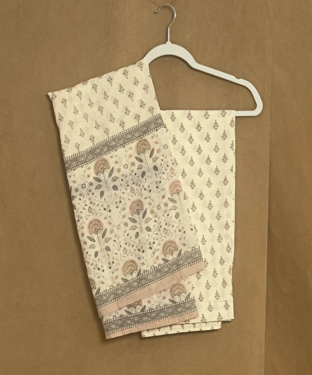Folded fabric with floral pattern on a hanger against a brown background