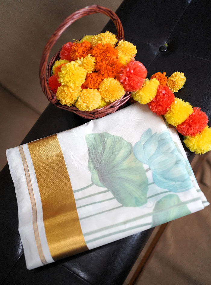 Decorative fabric with floral design and a basket of marigold flowers on a dark surface.
