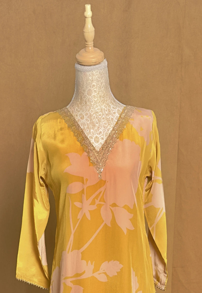 Yellow floral blouse on a mannequin against a brown background