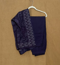 Navy blue saree with white patterns on a beige background