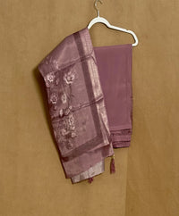 Purple saree with floral patterns on a beige background