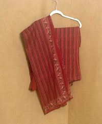 Red patterned fabric on a hanger against a beige background