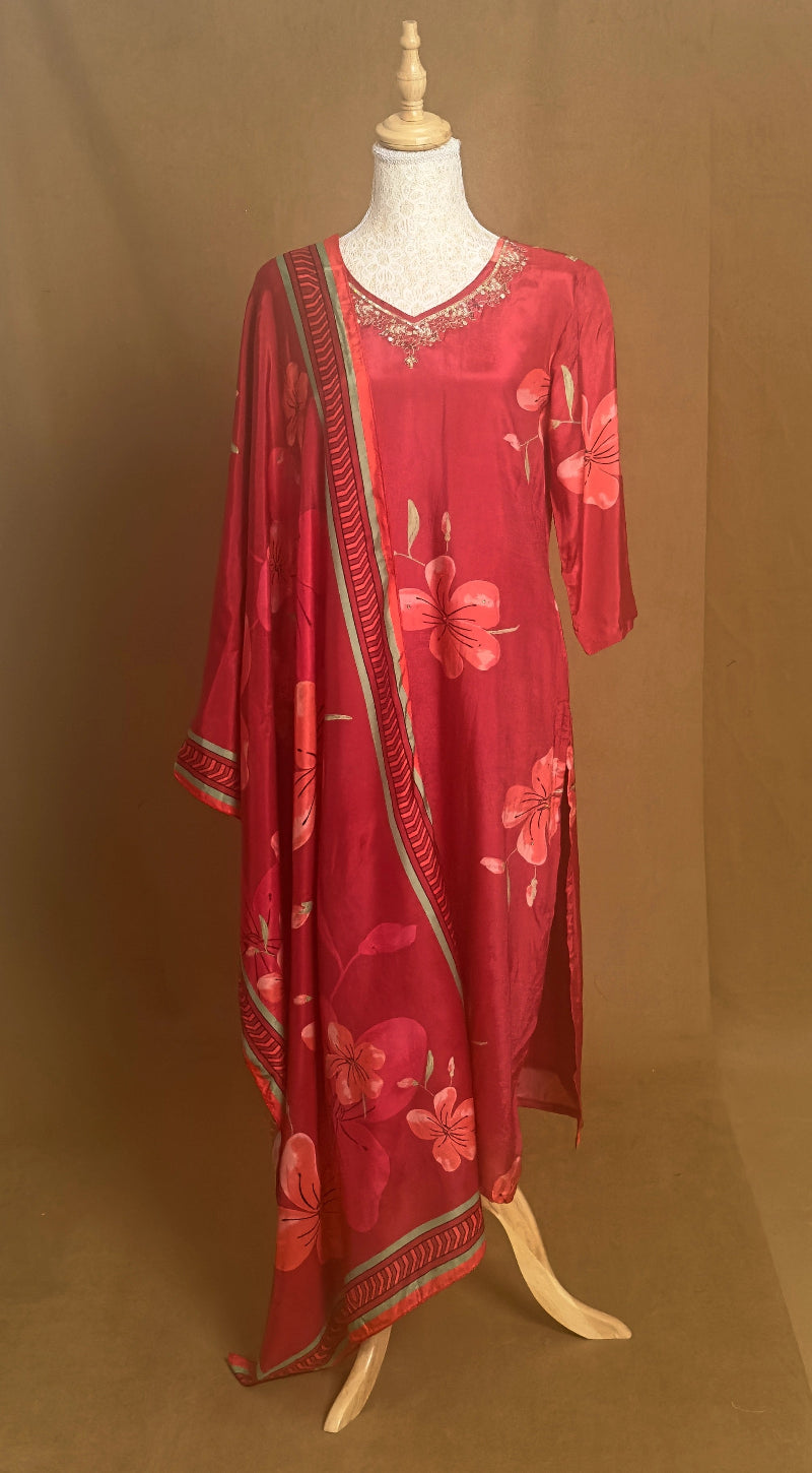 Red floral dress on a mannequin against a brown background