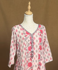 Floral patterned top on a mannequin against a brown background