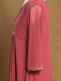 Red dress with floral embroidery on a brown background