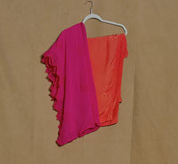 Two colorful dresses, one pink and one orange, on a hanger against a beige background.