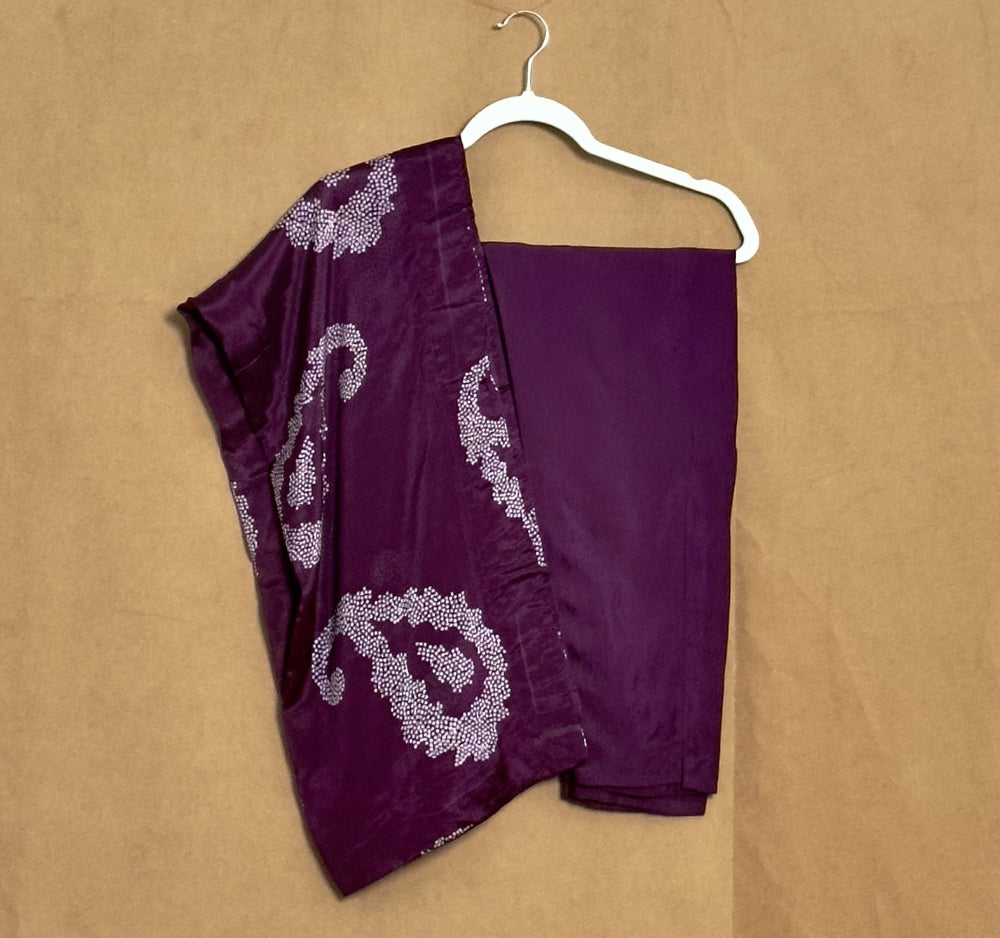 Purple garment with white patterns on a beige background