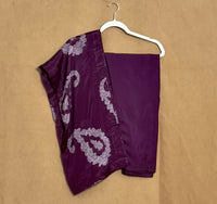 Purple garment with white patterns on a beige background