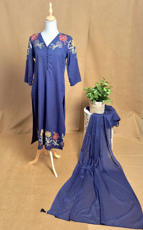 Blue dress with floral patterns on a mannequin against a brown background