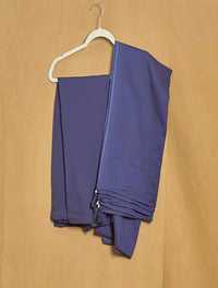 Purple fabric on a white hanger against a beige background