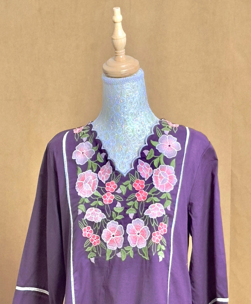Purple blouse with floral embroidery on a mannequin against a beige background
