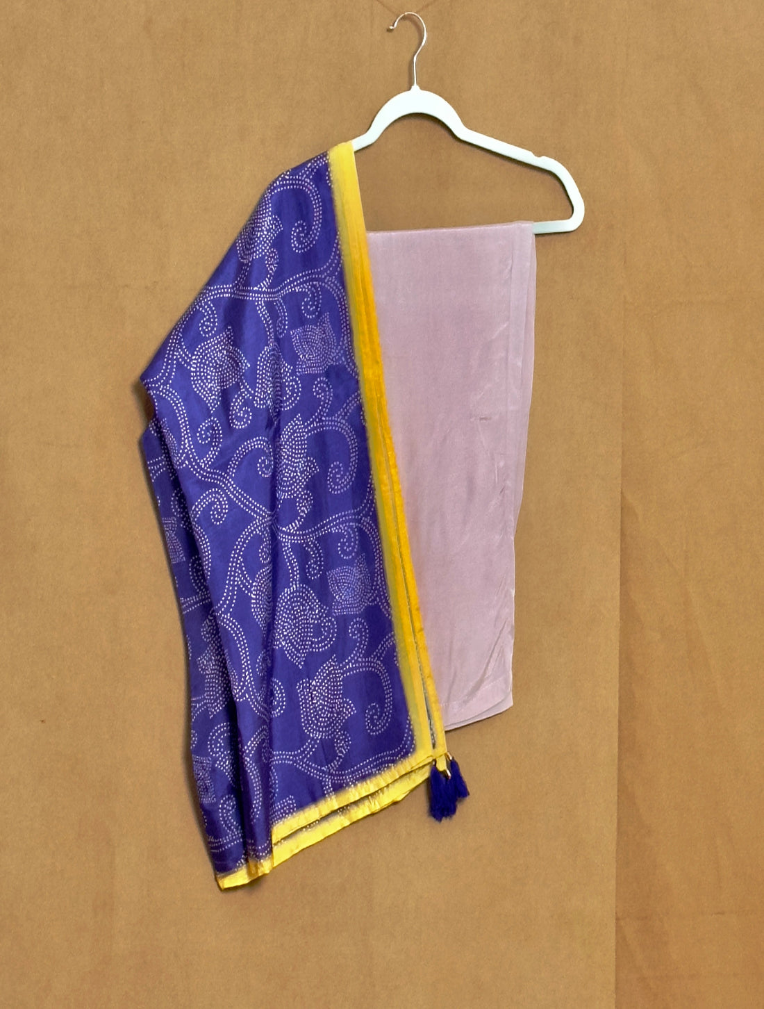 Purple and yellow fabric with a white pattern on a beige background