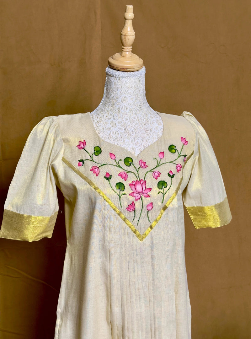 Beige dress with floral embroidery on a mannequin against a brown background